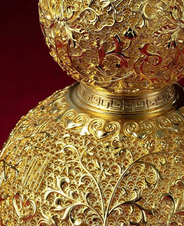 Close-up of the elegant neck and rim of a gold-plated Wu Lou ornament, featuring traditional geometric fretwork patterns.
