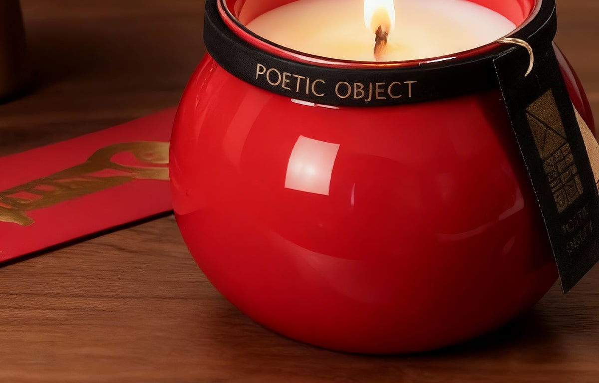 Macro detail of a vibrant red glazed porcelain vessel with luxury Poetic Object branding and a decorative black and red tag.