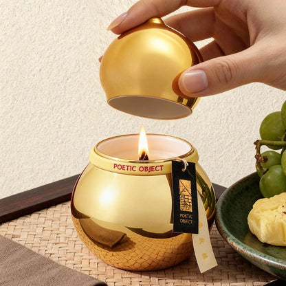Woman lifting the lid of a lit Golden Osmanthus aroma candle, creating a joyful and opulent atmosphere for home entertaining.